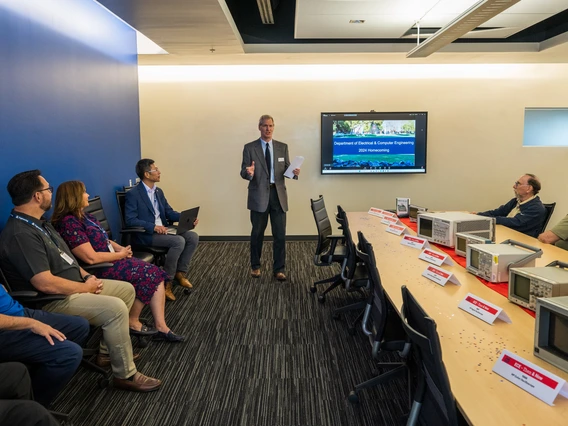 people seated at conference room table