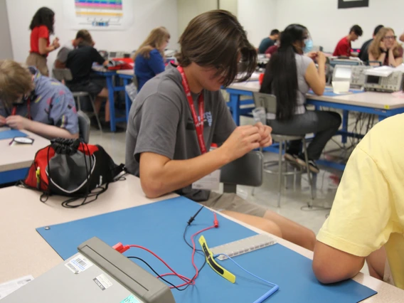 Students sitting in the classroom look at a semiconductor