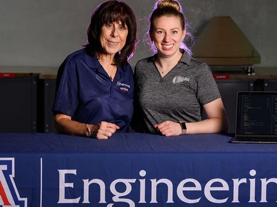 two people, standing behind Univ of AZ Engineering tablecloth