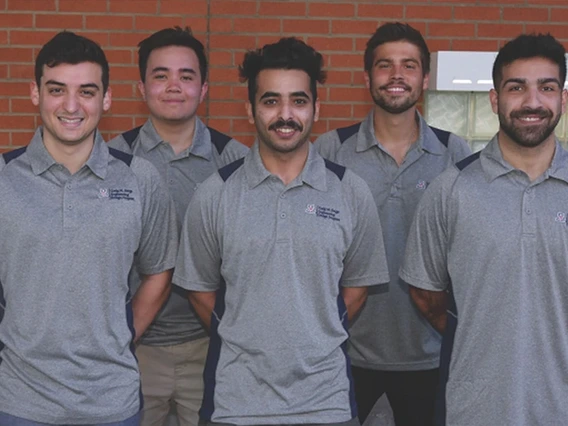 group of students, smiling, wearing gray t-shirts