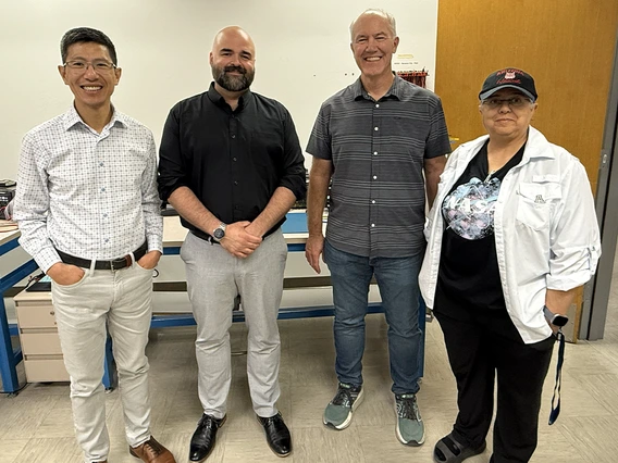 four people standing