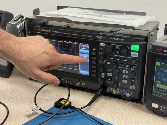finger pointing to electronic equipment