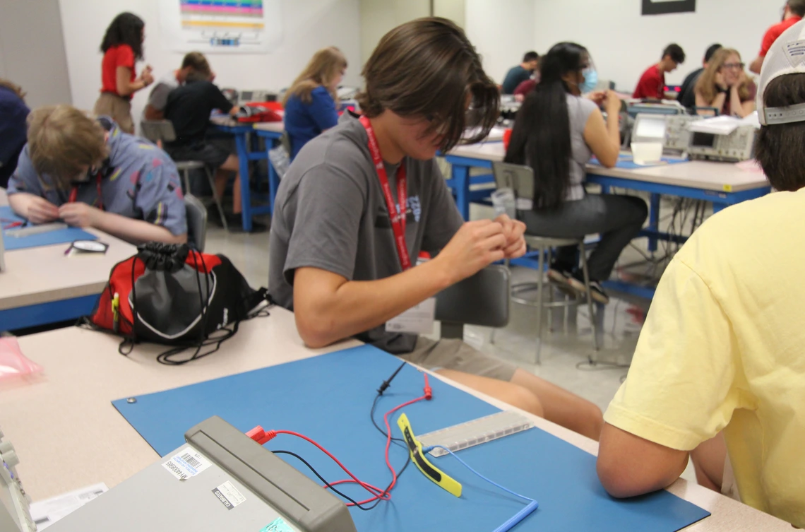 Students sitting in the classroom look at a semiconductor