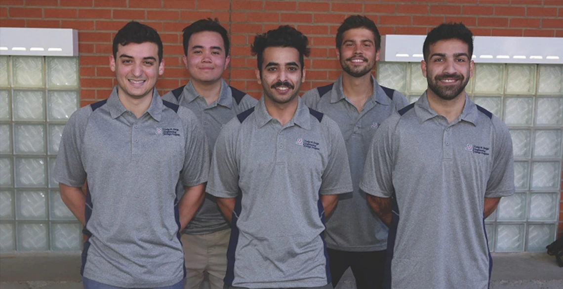 group of students, smiling, wearing gray t-shirts