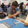 Students sitting in the classroom look at a semiconductor