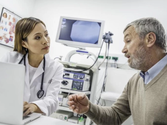 man speaking to woman in medical office