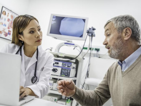 man speaking to woman in medical office