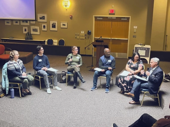 group of people, seated in circle