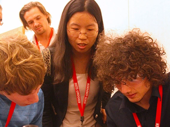 three students, soldering