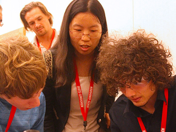 three students, soldering