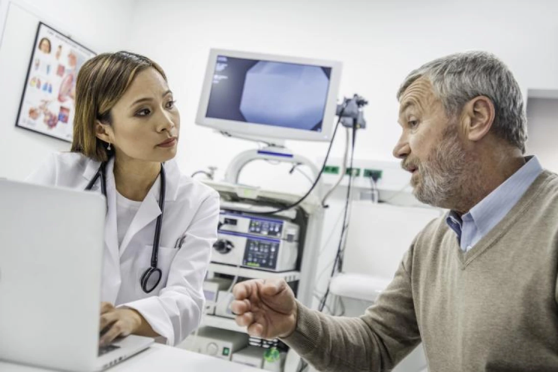 man speaking to woman in medical office