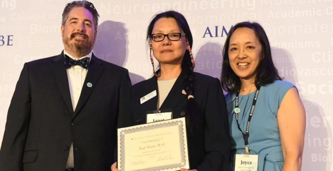 Janet Roveda, center, accepts her AIMBE fellowship certificate at the 2024 induction ceremony on March 25.