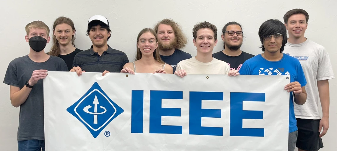 group of people, holding a IEEE banner