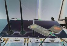 An experimental "box" transmitter and receiver is shown with two reconfigurable antennas similar to those in development by professors Marwan Krunz and Hao Xin.