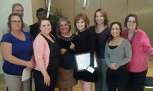 Rozanne Canizales (center) celebrates her award with members of the ECE team.