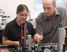 Raymond Kostuk and one of his grad students, Isela Howlett, test the new bench-top imaging instrument for ovarian cancer.