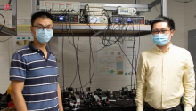 Assistant professors Quntao Zhuang and Zheshen Zhang standing in a lab. 