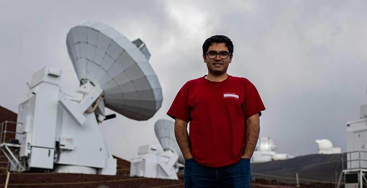 Electrical engineering doctoral student Arash Roshanineshat at the Submillimeter Array, an array of eight 6-meter telescopes in Mauna Kea, Hawaii. 