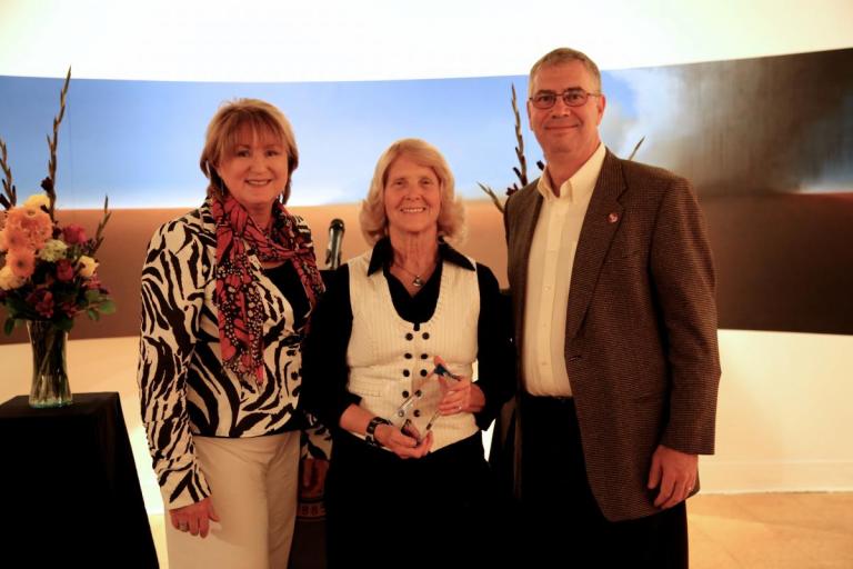 UA President Ann Weaver Hart (left) and College of Engineering dean Jeff Goldberg (right) present ECE professor Linda Powers with the i-Squared Award for Innovation and Impact at the second annual Tech Launch Arizona awards event. 