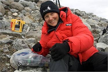 UA Professor Linda Powers, shown here in the Arctic with one of her instruments, is taking her portable technology to a new level: diagnosing blood-borne disease.