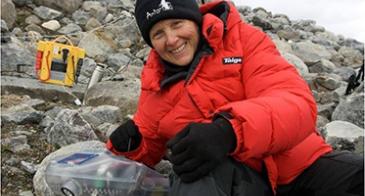 UA Professor Linda Powers, shown here in the Arctic with one of her instruments, is taking her portable technology to a new level: diagnosing blood-borne disease.