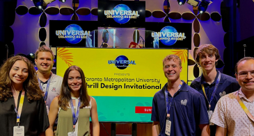 Six students from the UA Theme Park Entertainment Group pose for a photo at the Toronto Metropolitan University Thrill Design Invitational competition in Orlando, Florida.